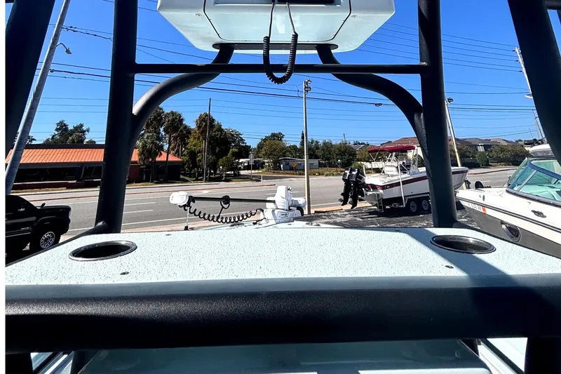 Slide: The Image of 2021 Yellowfin 26 Hybrid boat on display at a dealership with clear blue sky. - 12