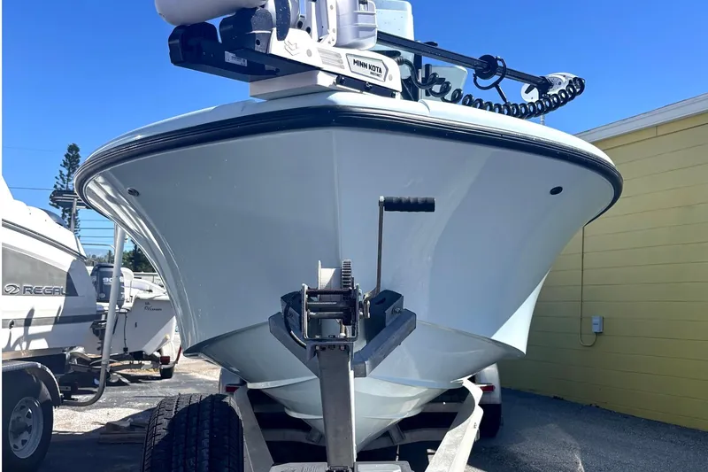 Slide: The Image of 2021 Yellowfin 26 Hybrid boat on trailer, front view, clear blue sky. - 16