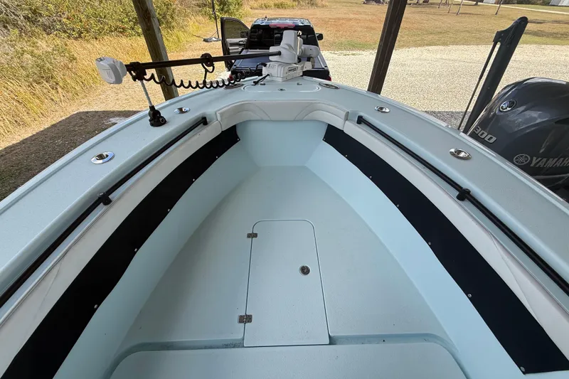 Slide: The Image of 2021 Yellowfin 26 Hybrid boat interior with Yamaha engine, featuring spacious deck and trolling motor. - 21