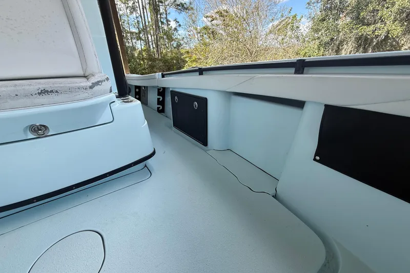 Slide: The Image of 2021 Yellowfin 26 Hybrid boat interior with seating and storage compartments. - 25