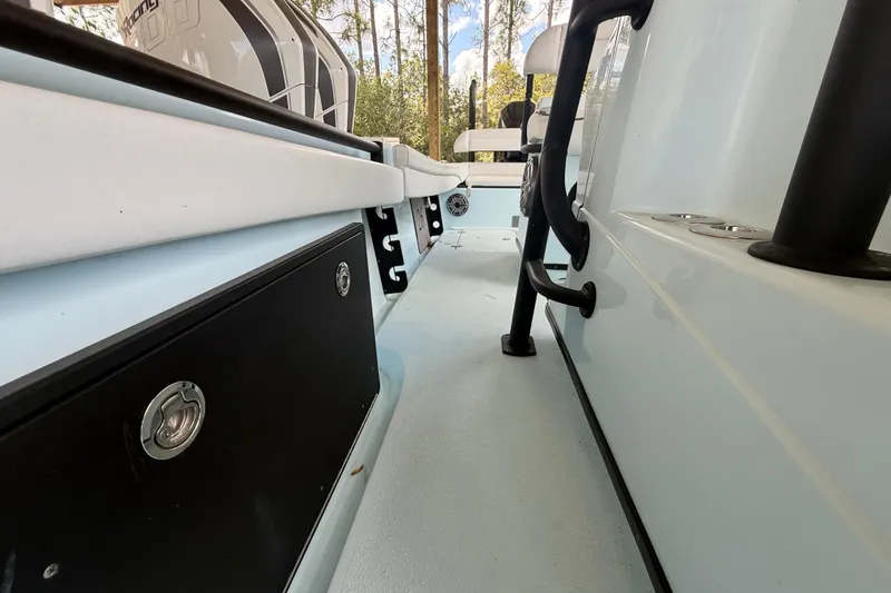 Slide: The Image of 2021 Yellowfin 26 Hybrid boat interior with storage compartments and seating. - 26