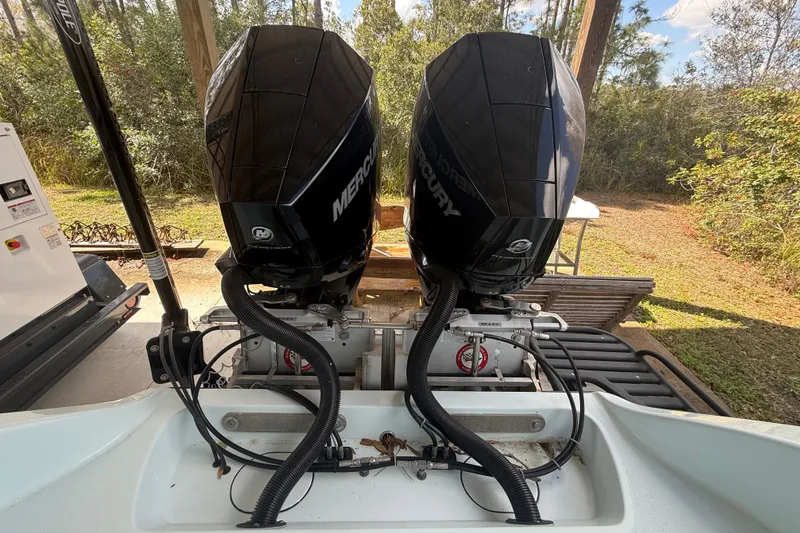 Slide: The Image of Twin Mercury outboard engines on a 2021 Yellowfin 26 Hybrid boat, parked outdoors. - 31