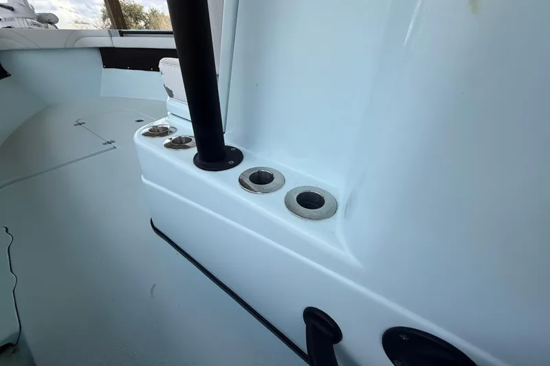 Slide: The Image of 2021 Yellowfin 26 Hybrid boat interior with rod holders and seating area. - 37