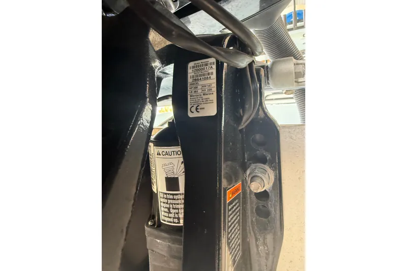 Slide: The Image of Close-up of 2021 Yellowfin 26 Hybrid boat engine components and warning labels. - 42