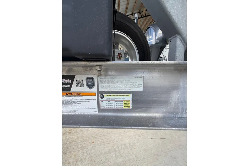 Slide: The Image of Trailer warning labels and tire information for 2021 Yellowfin 26 Hybrid boat. - 44