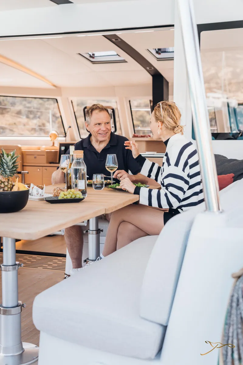Slide: The Image of Couple dining on Nautitech 44 Open yacht, 2025 model, enjoying a meal indoors. - 27