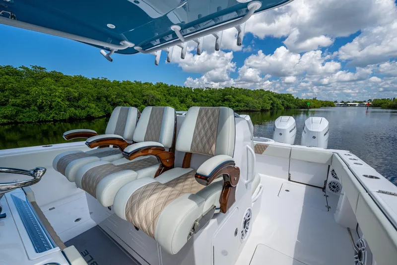 Slide: The Image of Luxurious seating on 2025 Invincible 37 Catamaran, cruising through scenic waterway. - 12