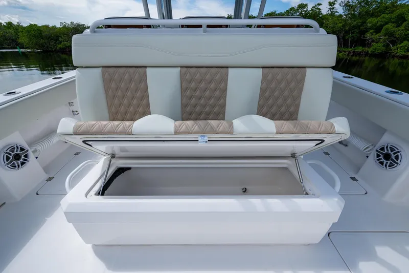 Slide: The Image of 2025 Invincible 37 Catamaran with open storage compartment and cushioned seating. - 15