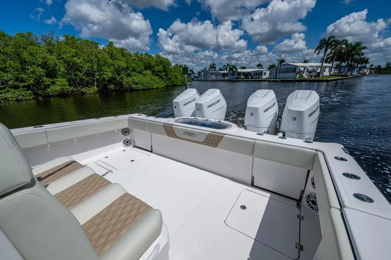 Slide: The Image of 2025 Invincible 37 Catamaran with quad engines, cruising on a scenic waterway. - 17