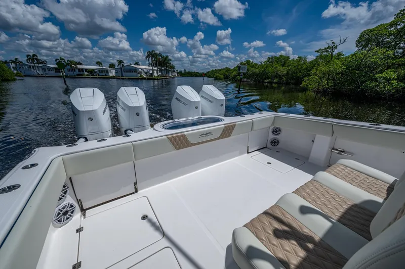 Slide: The Image of 2025 Invincible 37 Catamaran with triple Mercury engines on a scenic waterway. - 18