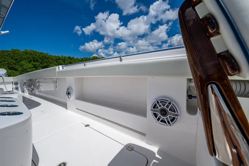 Slide: The Image of 2025 Invincible 37 Catamaran deck with speakers, under a bright blue sky. - 24