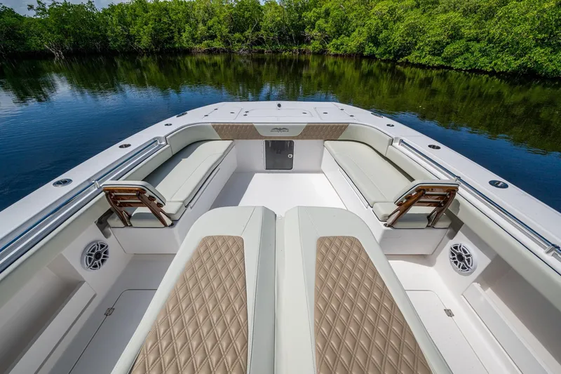 Slide: The Image of 2025 Invincible 37 Catamaran interior with luxurious seating and scenic water view. - 25