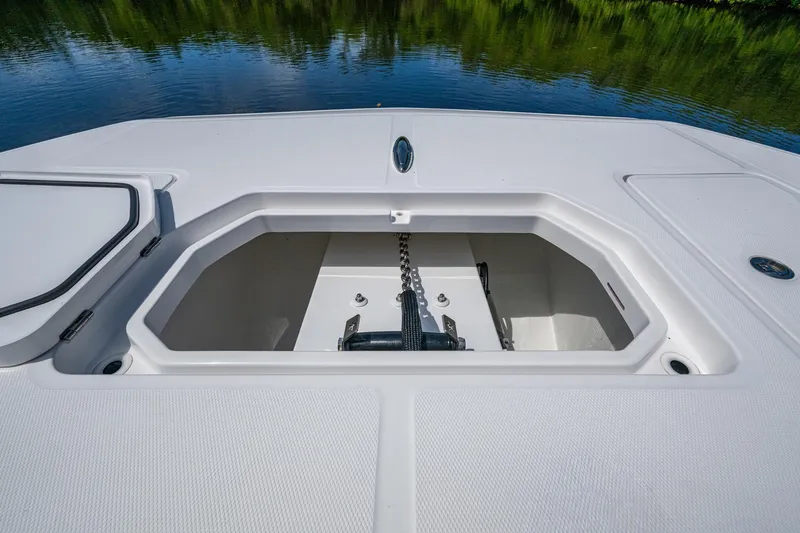 Slide: The Image of 2025 Invincible 37 Catamaran anchor locker with chain, on calm water. - 27