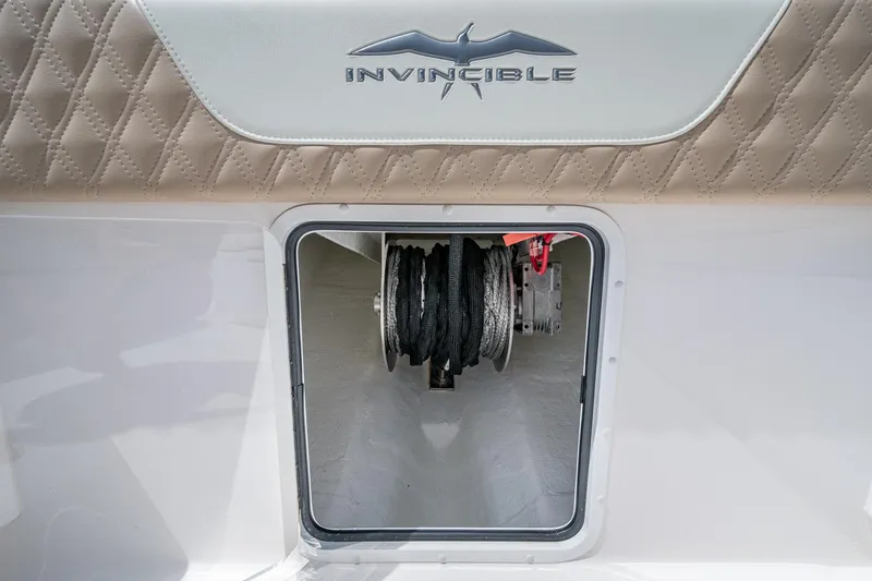 Slide: The Image of 2025 Invincible 37 Catamaran anchor storage with logo and quilted upholstery. - 28