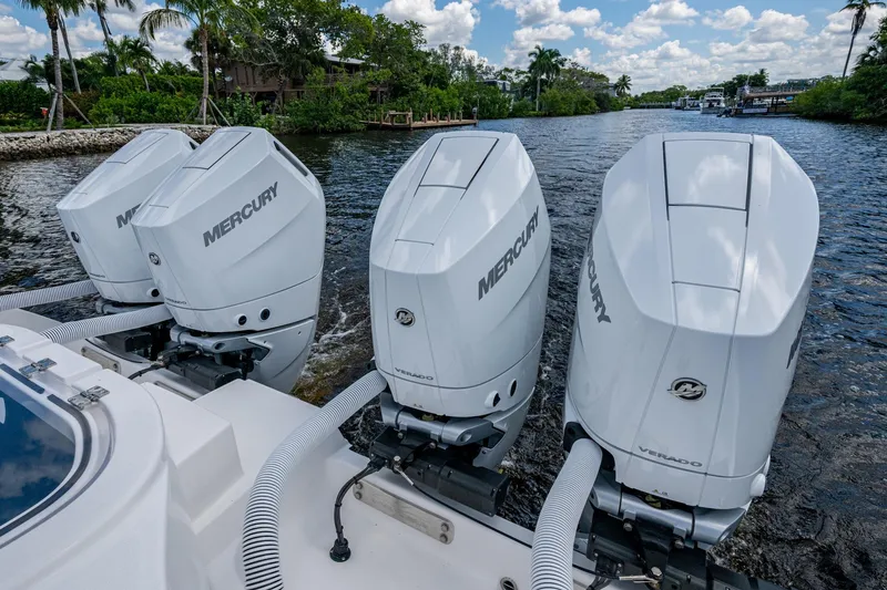 Slide: The Image of 2025 Invincible 37 Catamaran with four Mercury outboard engines on a scenic waterway. - 29