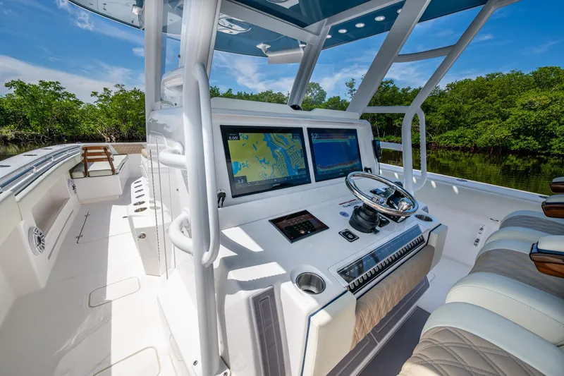 Slide: The Image of 2025 Invincible 37 Catamaran cockpit with advanced navigation system and luxurious seating. - 7