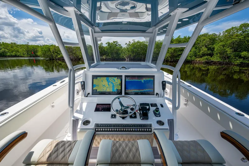 Slide: The Image of 2025 Invincible 37 Catamaran helm with advanced navigation systems and luxurious seating. - 8