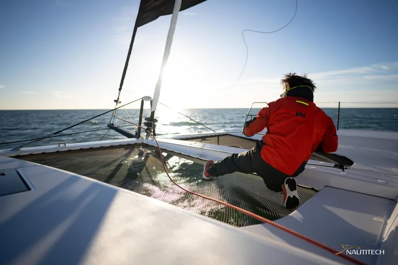 Slide: The Image of Person sailing on Nautitech 48 Open catamaran, 2025 model, enjoying the ocean view. - 15