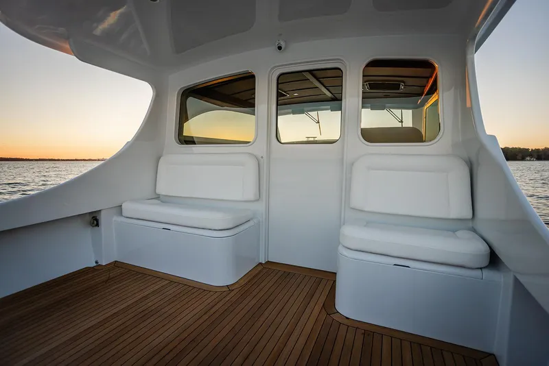 Slide: The Image of Luxurious 2027 Composite Yacht CY39 interior with white seating and wooden flooring at sunset. - 10
