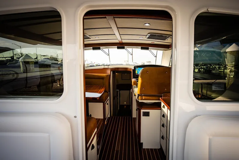 Slide: The Image of Interior view of 2027 Composite Yacht CY39, featuring elegant seating and modern navigation equipment. - 12