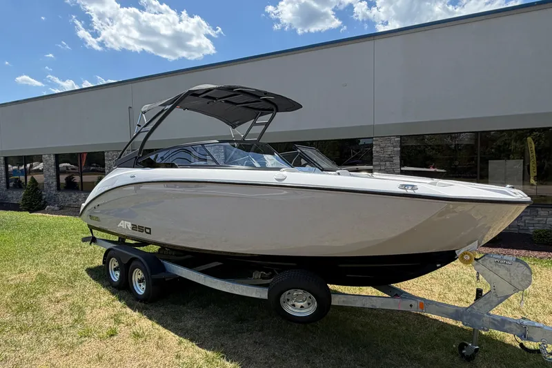 Slide: The Image of 2026 Yamaha Boats AR250 on trailer, displayed outdoors under a sunny sky. - 11