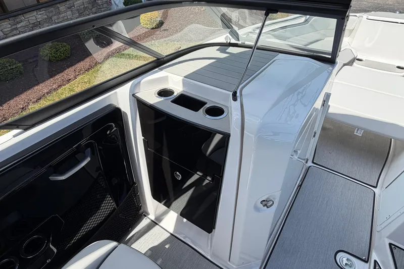 Slide: The Image of 2026 Yamaha Boats AR250 interior with sleek design and cup holders. - 12