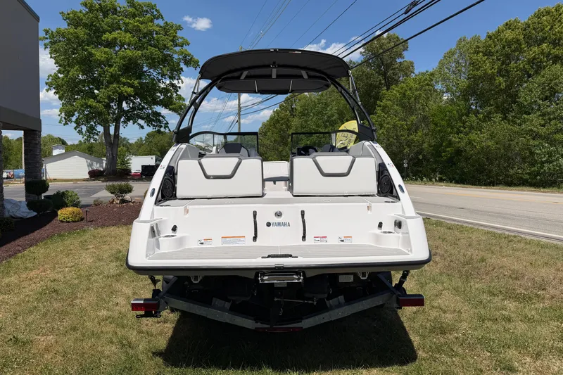 Slide: The Image of 2026 Yamaha Boats AR250 on grass, showcasing sleek design and spacious seating. - 17