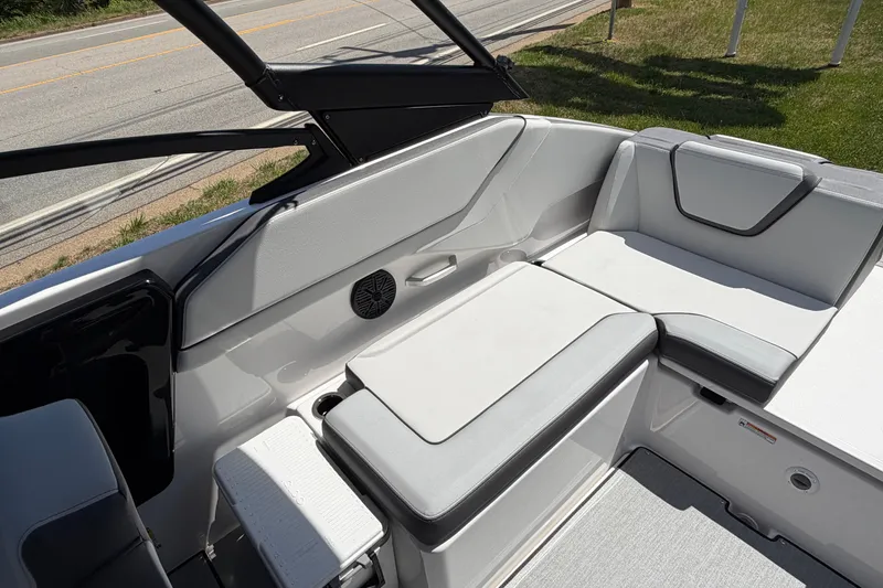 Slide: The Image of 2026 Yamaha Boats AR250 interior seating with modern design and speaker system. - 8