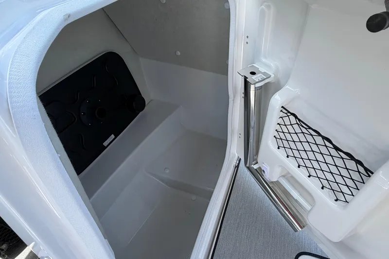 Slide: The Image of Interior storage compartment of 2026 Yamaha Boats AR250 with netted pocket and sleek design. - 9