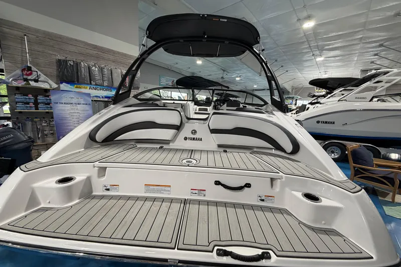 Slide: The Image of 2026 Yamaha Boats AR195 interior view in showroom, showcasing seating and deck layout. - 5