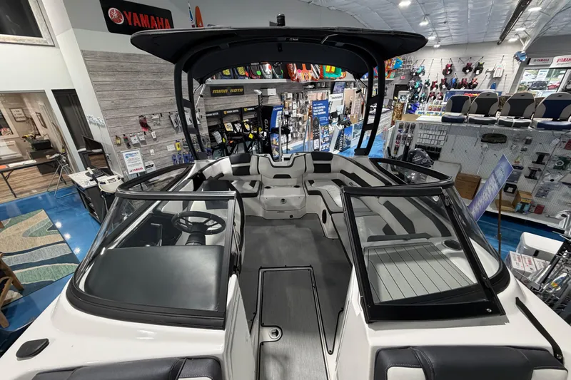 Slide: The Image of 2026 Yamaha Boats AR195 interior view in showroom, featuring sleek design and seating. - 7
