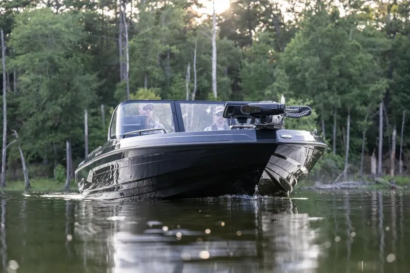 Slide: The Image of Manufacturer Provided Image: 2026 Skeeter WXR2060 F boat cruising on a calm lake with forest backdrop. - 10