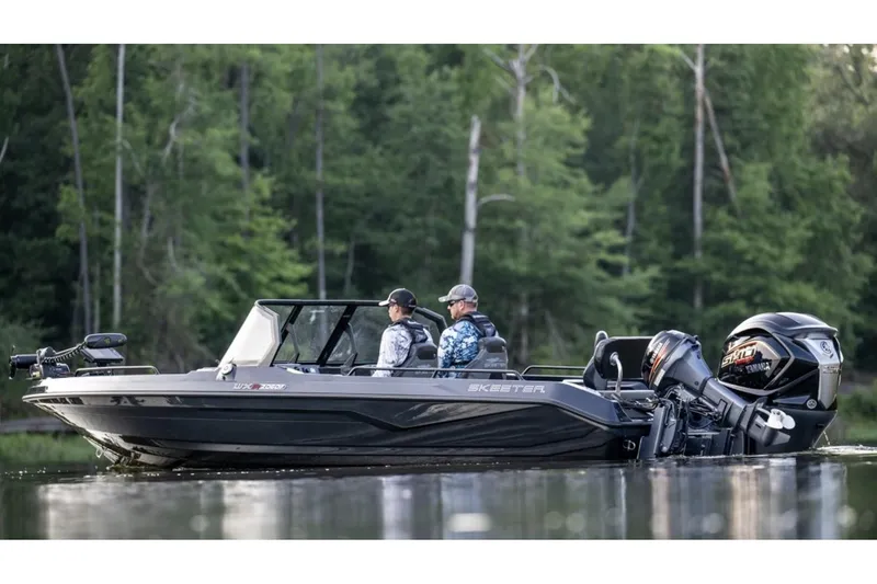 Slide: The Image of Manufacturer Provided Image: 2026 Skeeter WXR2060 F boat on calm water with two passengers, surrounded by lush forest. - 11