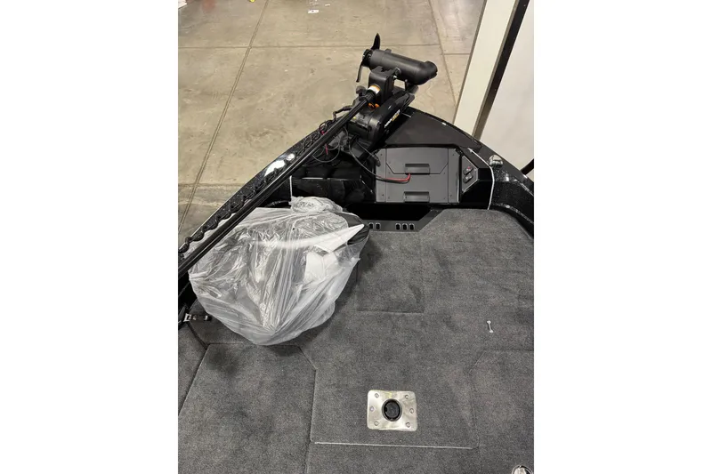 Slide: The Image of 2026 Skeeter WXR2060 F boat interior with motor and carpeted deck. - 13