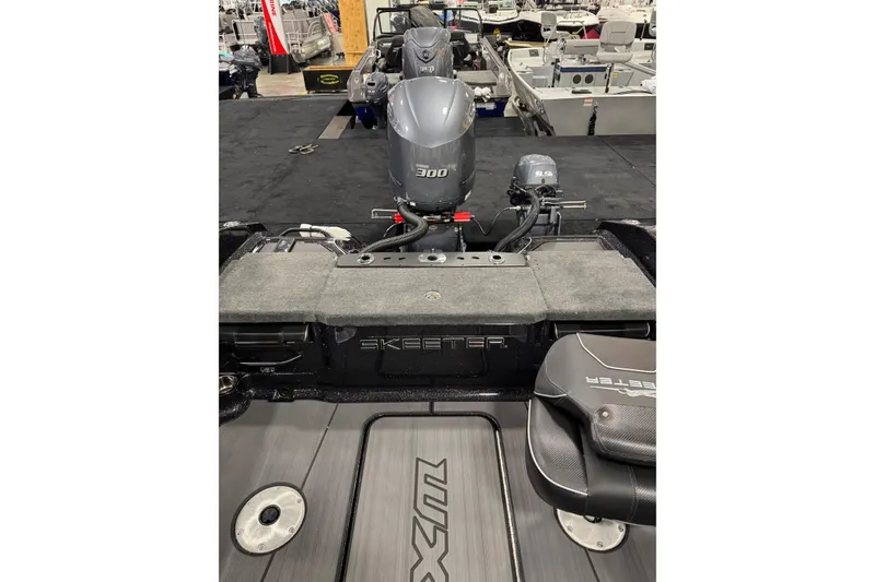 Slide: The Image of 2026 Skeeter WXR2060 F boat with dual engines displayed at a boat show. - 3