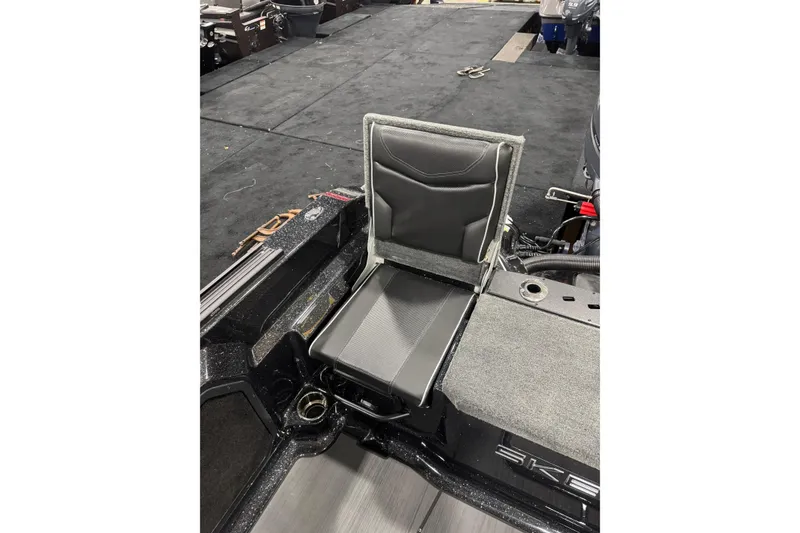 Slide: The Image of 2026 Skeeter WXR2060 F boat seat with sleek black and gray design. - 4