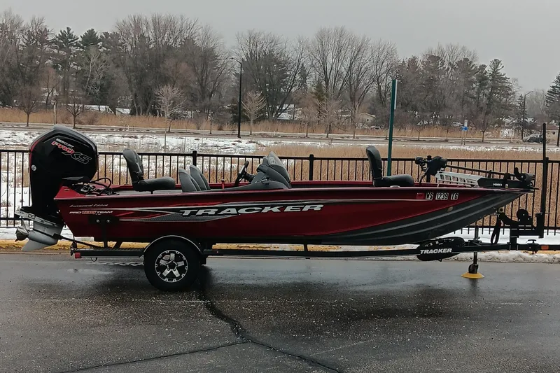 The Image of 2019 Tracker Pro Team 195 TXW Tournament Edition boat on trailer, parked outdoors. - 0