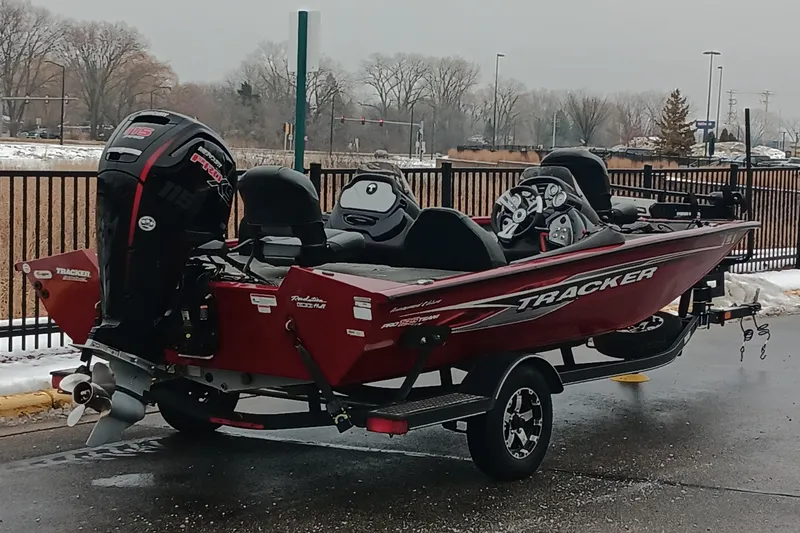 Slide: The Image of 2019 Tracker Pro Team 195 TXW Tournament Edition boat on trailer, parked outdoors. - 3