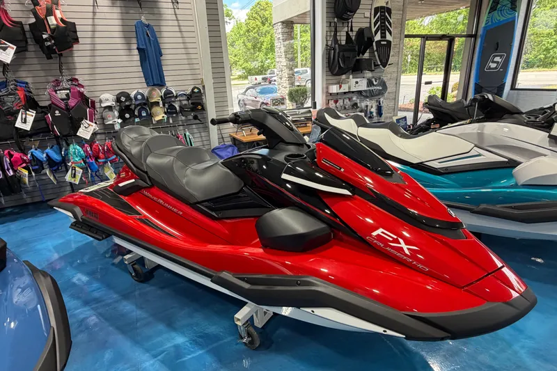 The Image of 2026 Yamaha WaveRunner FX Cruiser HO in showroom, vibrant red color, displayed with accessories. - 0