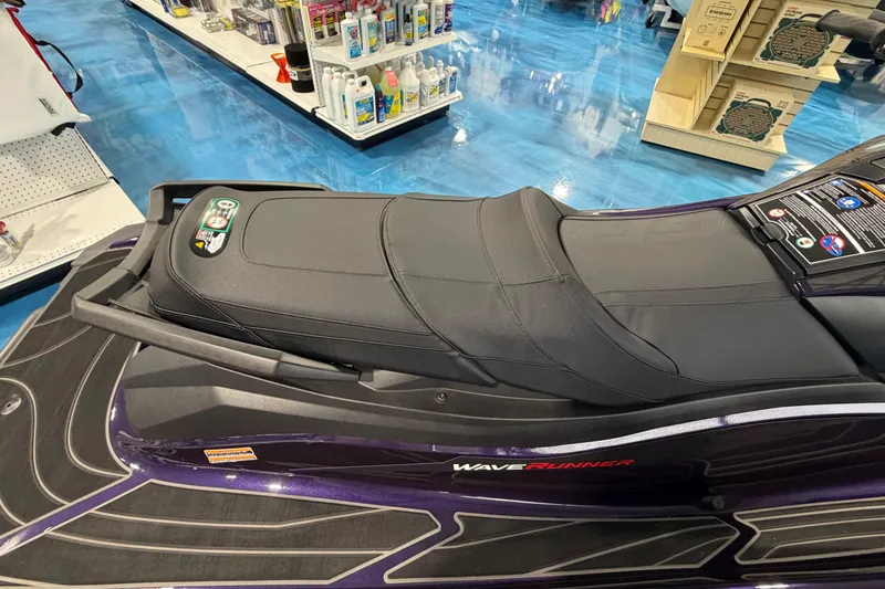 Slide: The Image of 2026 Yamaha WaveRunner GP HO jet ski seat in a showroom with blue flooring. - 4