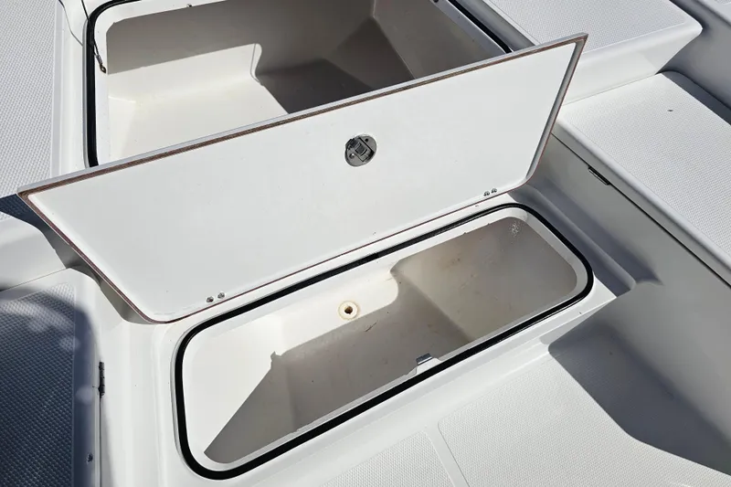 Slide: The Image of Open storage compartment on 2013 BlackJack 224 boat, showcasing interior space. - 18