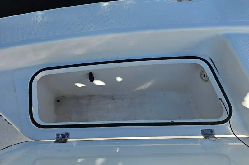 Slide: The Image of Open storage compartment on a 2013 BlackJack 224 boat, showing interior details. - 20