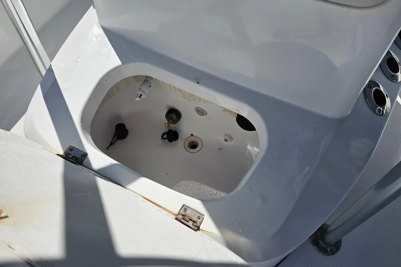 Slide: The Image of Open compartment on a 2013 BlackJack 224 boat, showing interior details and fittings. - 22