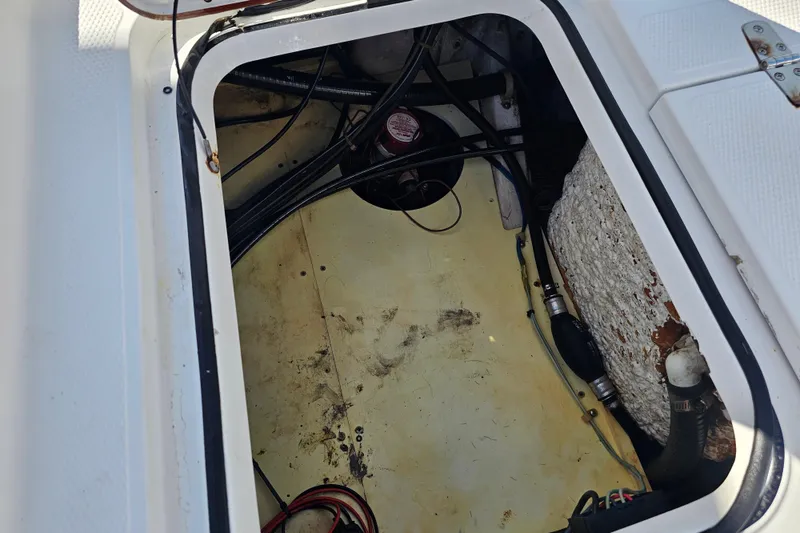 Slide: The Image of Open hatch of 2013 BlackJack 224 boat showing internal wiring and components. - 24