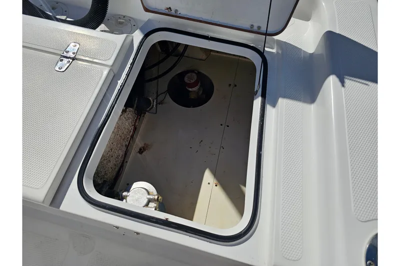 Slide: The Image of Open storage compartment on 2013 BlackJack 224 boat, showing interior details. - 26