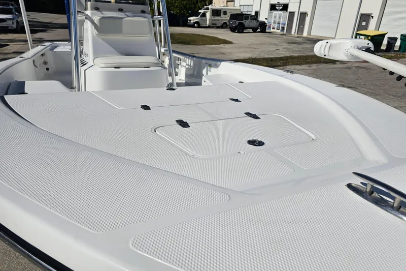 Slide: The Image of 2013 BlackJack 224 boat on trailer, featuring Minn Kota trolling motor, parked outdoors. - 3