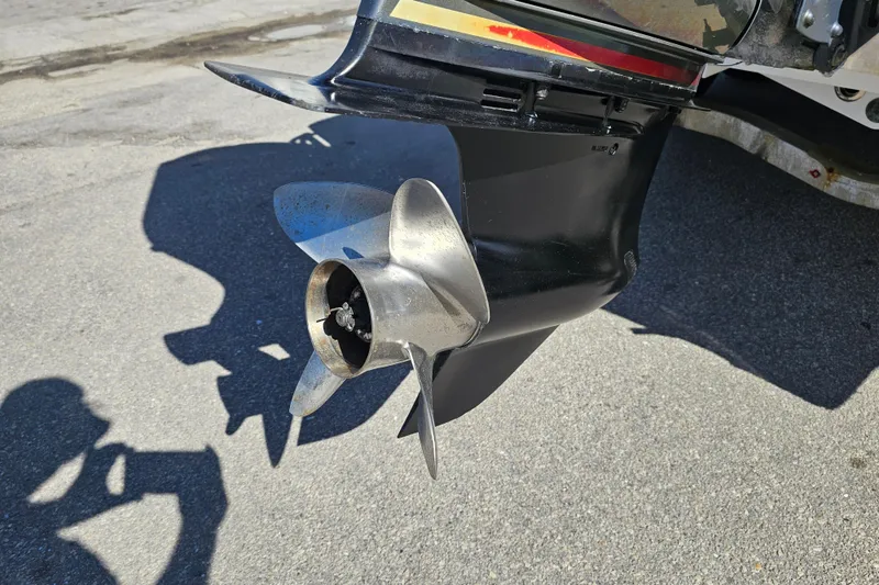 Slide: The Image of 2013 BlackJack 224 boat on trailer with Yamaha outboard motor, parked outdoors. - 6