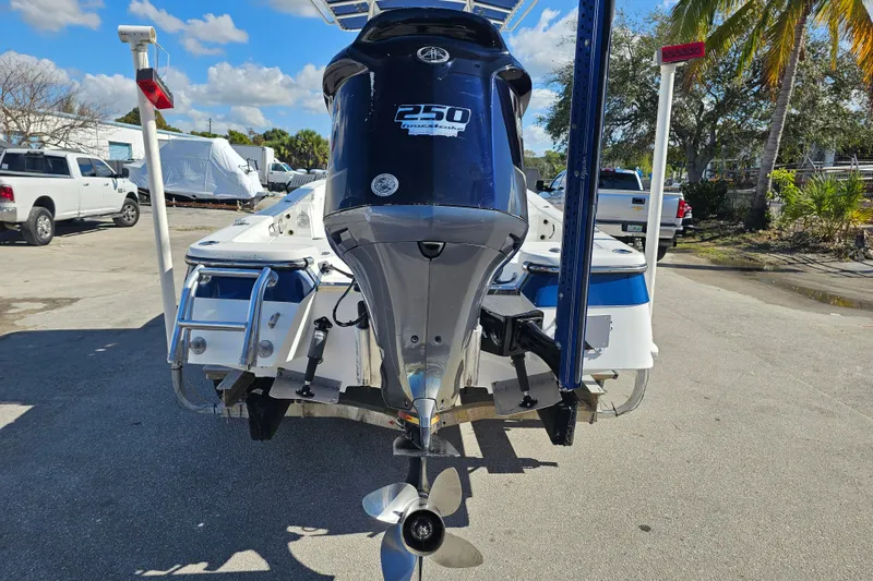 Slide: The Image of 2013 BlackJack 224 boat on trailer with Yamaha outboard motor, parked outdoors. - 7