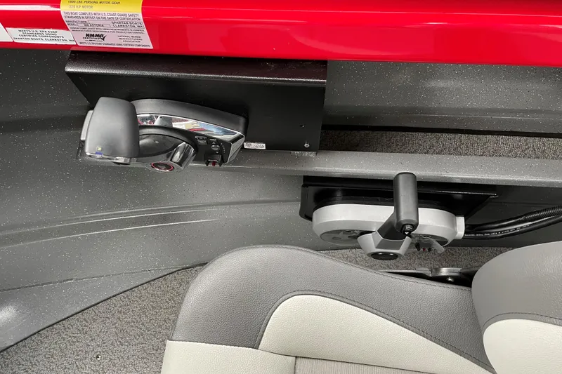 Slide: The Image of 2024 Spartan 200 Astoria boat controls and seating detail, featuring modern design and functionality. - 10