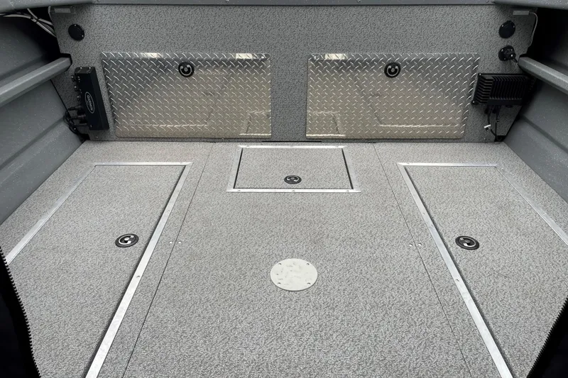 Slide: The Image of 2024 Spartan 200 Astoria boat interior with diamond plate accents and storage compartments. - 15